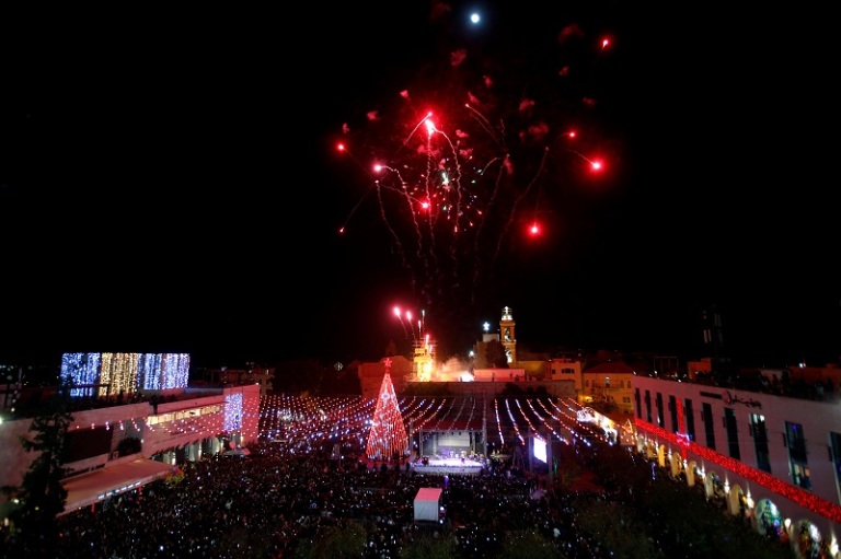 Fireworks explode during a Christmas tree lighting ceremony outside the Church of the Nativity in the West Bank town of Bethlehem
